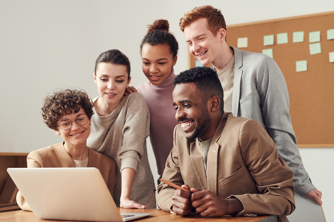 Image of people around a computer
